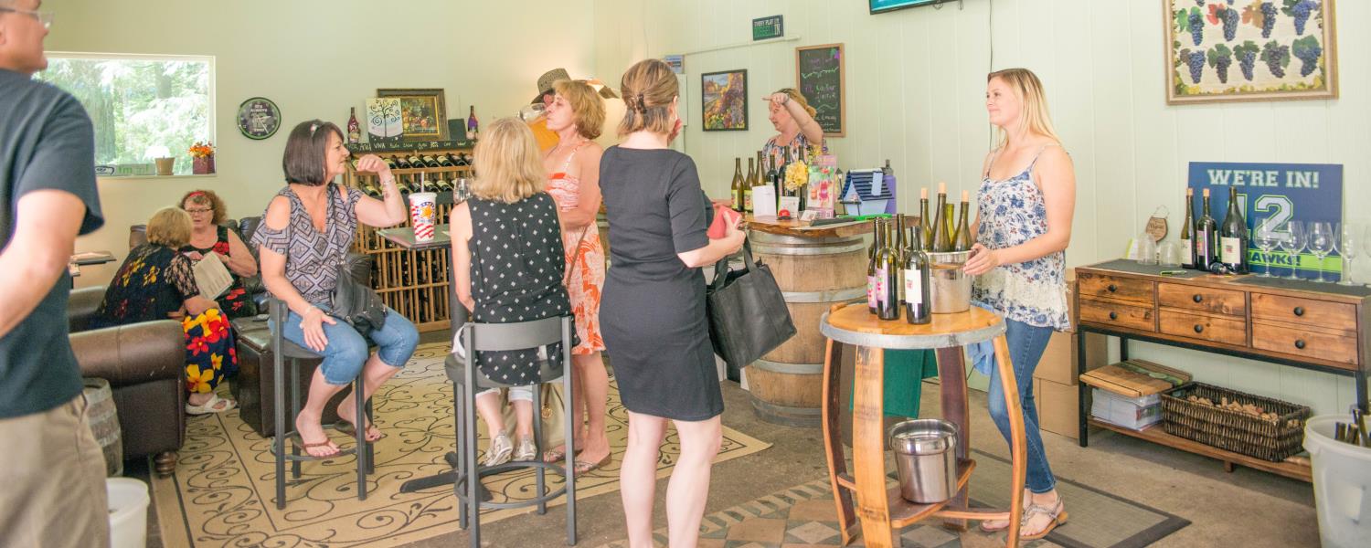 Inside Cedar River Cellars Tasting Room with people enjoying wine and conversation.